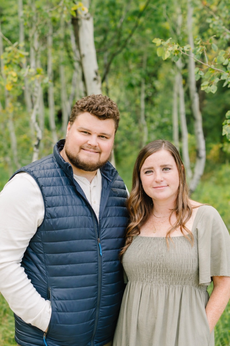 Junior and Mallory Vanden Brink standing among aspen trees